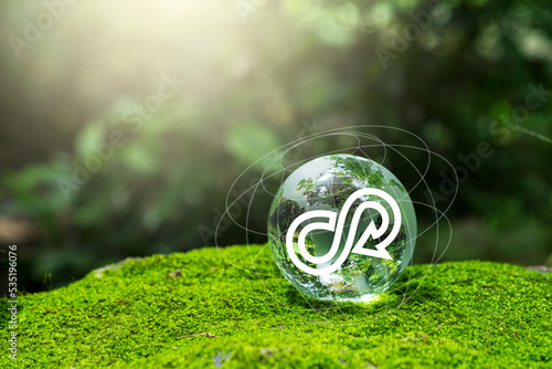 Crystal globe with a circular economy icon around it. Ideas for future growth of business and design to reuse and renewable material resources.reuse. Circular economy concept.