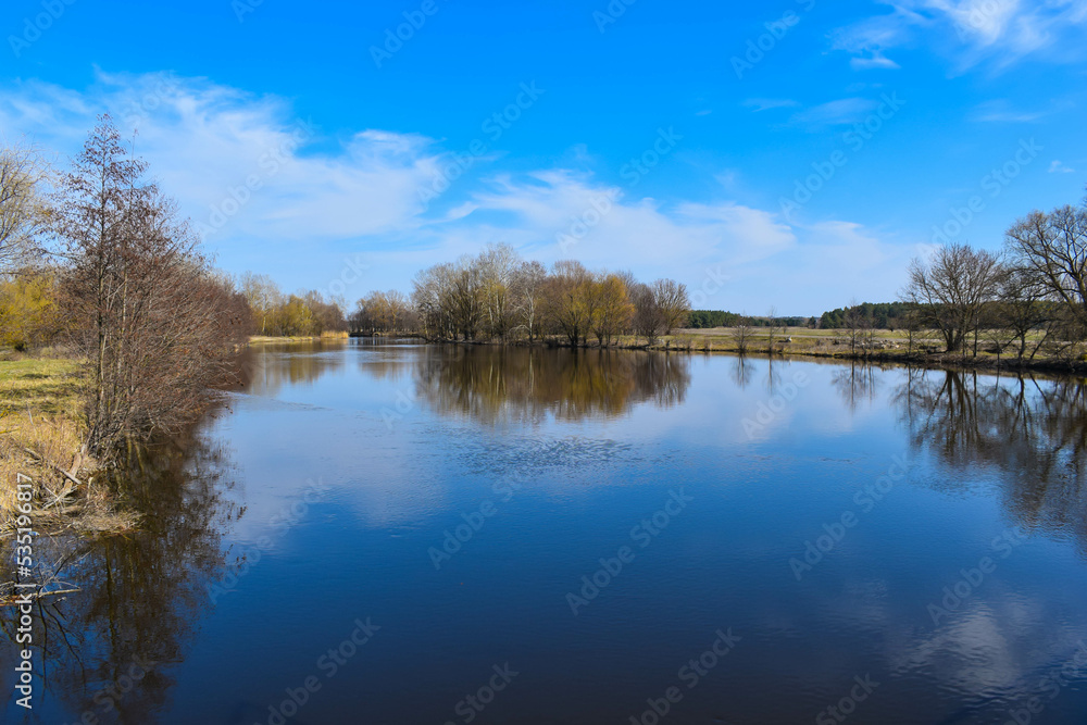 The river on the background of the blue sky in the afternoon in autumn