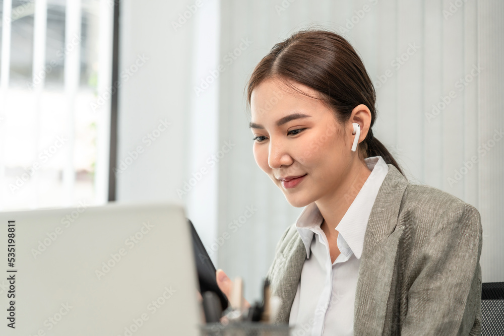 Professional marketing leader uses in-depth analytics tablet to advance the organizational structure, Using a laptop for telecommunication work, Works in a modern office Professional marketing leader uses in-depth analytics tablet to advance the organizational structure, Using a laptop for telecommunication work, Works in a modern office