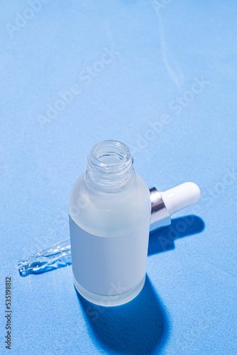 Laboratory equipment with advertising backgrounds. Medical flasks, bowls. Chemical laboratory research of cosmetics. Serums for the face.