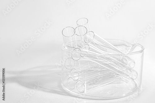 Laboratory equipment with advertising backgrounds. Medical flasks, bowls. Chemical laboratory research of cosmetics. Serums for the face.