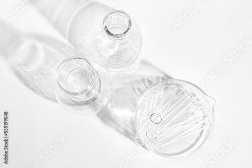 Laboratory equipment with advertising backgrounds. Medical flasks, bowls. Chemical laboratory research of cosmetics. Serums for the face.