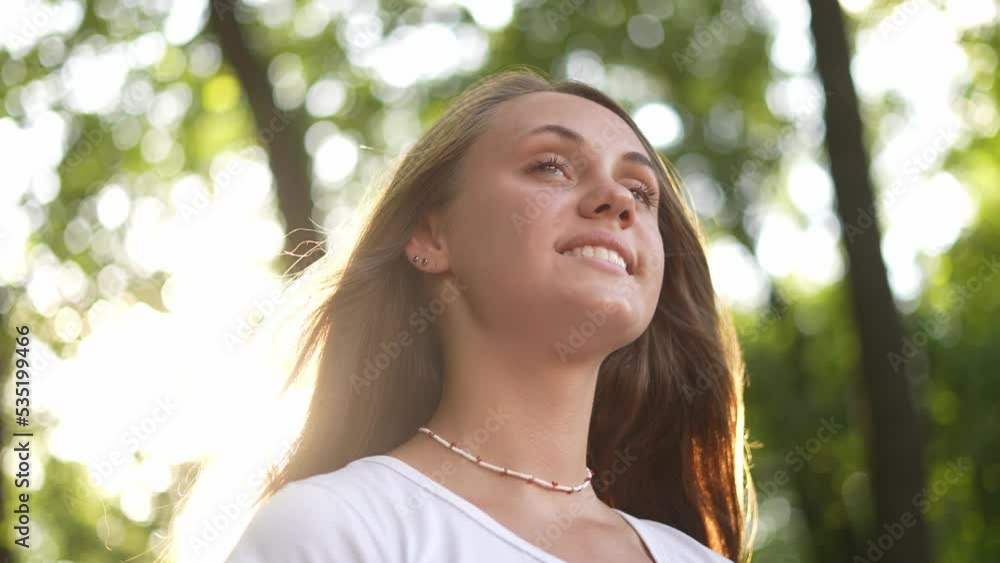 people in the park. beautiful girl smiling a portrait outdoors in the park. happy family young girl teenager concept. close-up girl teenager the glare of the sun dream in the forest people in the park. beautiful girl smiling a portrait outdoors in the park. happy family young girl teenager concept. close-up girl teenager the glare of the sun dream in the forest