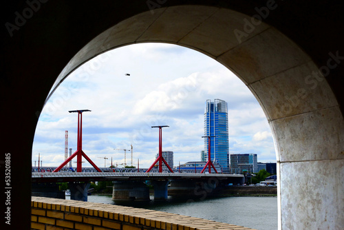 Photography perspective view of the Rakoczi bridge in Budapest with mid rise and high-rise glass office buildings in a distance