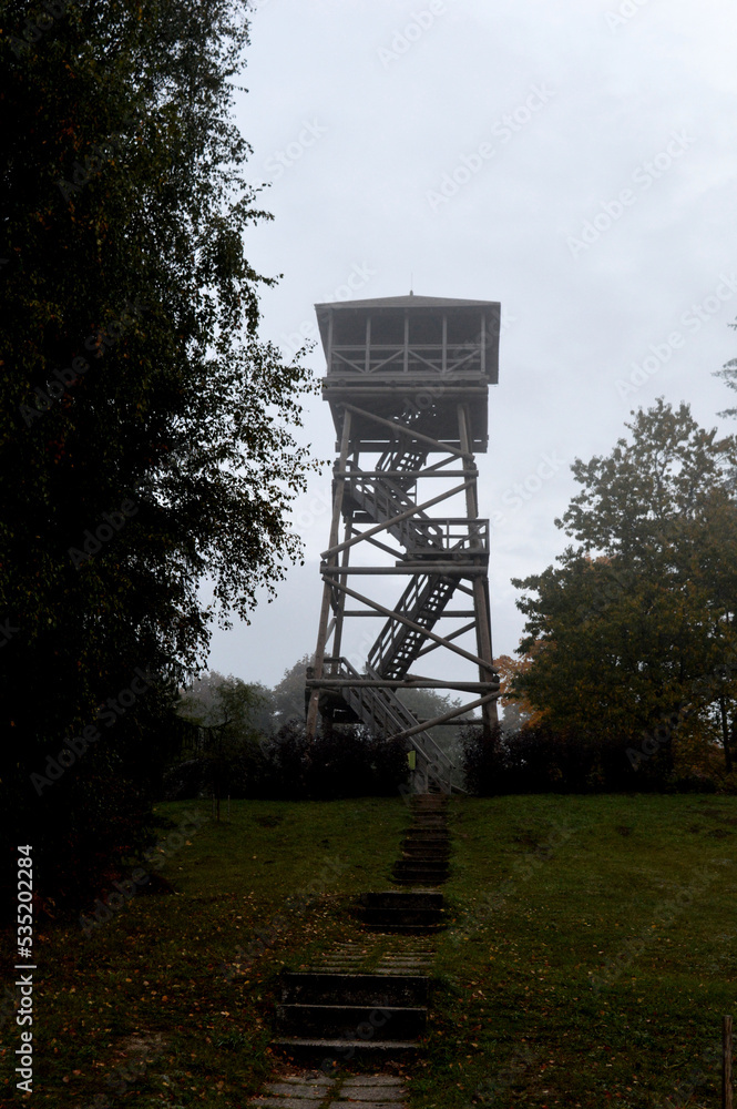 old watchtower in autumn foggy day