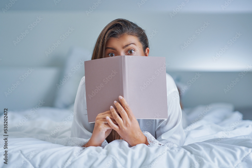 Brunette woman on bad with notepad or book Brunette woman on bad with notepad or book