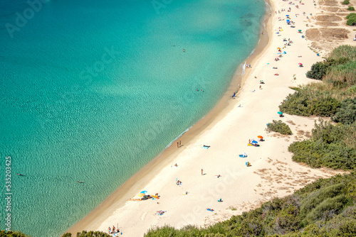Fototapeta Naklejka Na Ścianę i Meble -  Aerial view on the beach Solanas with white sand, hills with green vegetation, sea with blue transparent water and village in the province Sinnai. Location Sardinia, Italy.

