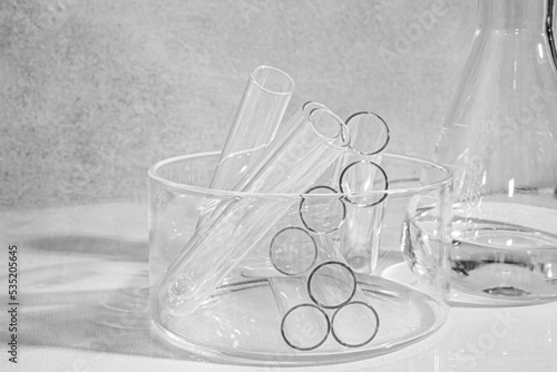 Transparent glass flask on a white background. science research chemistry banner laboratory background. Serum with a pipette in the laboratory. Cosmetic research.