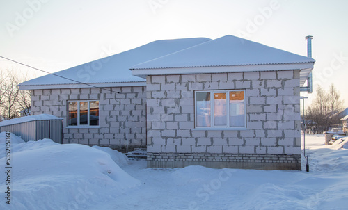 One-story house covered with snow.