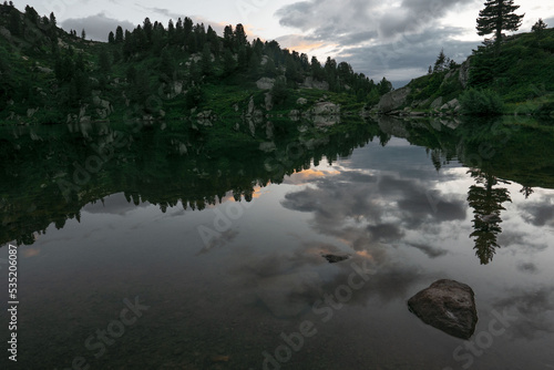 beautiful sunset reflection in lago delle stellune in the Italian alps
