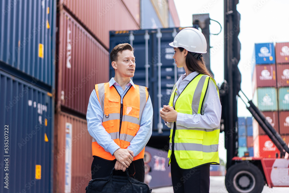 Caucasian business man and woman worker working in container terminal. Caucasian business man and woman worker working in container terminal.