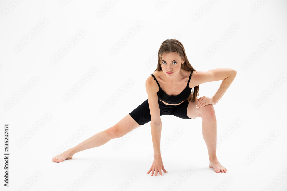 Beautiful brunette fitness woman doing yoga on a white background Beautiful brunette fitness woman doing yoga on a white background