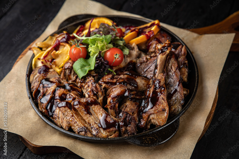 grilled meat with vegetables and spices on a black background
grilled meat with vegetables and spices on a black background