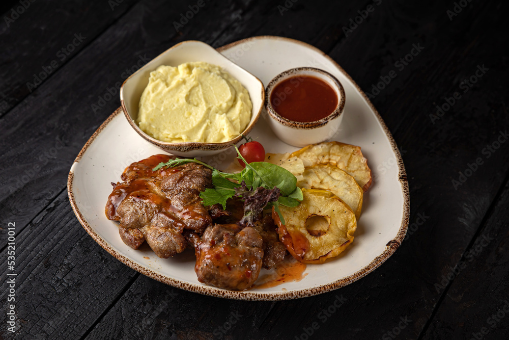grilled meat with vegetables and spices on a black background
grilled meat with vegetables and spices on a black background