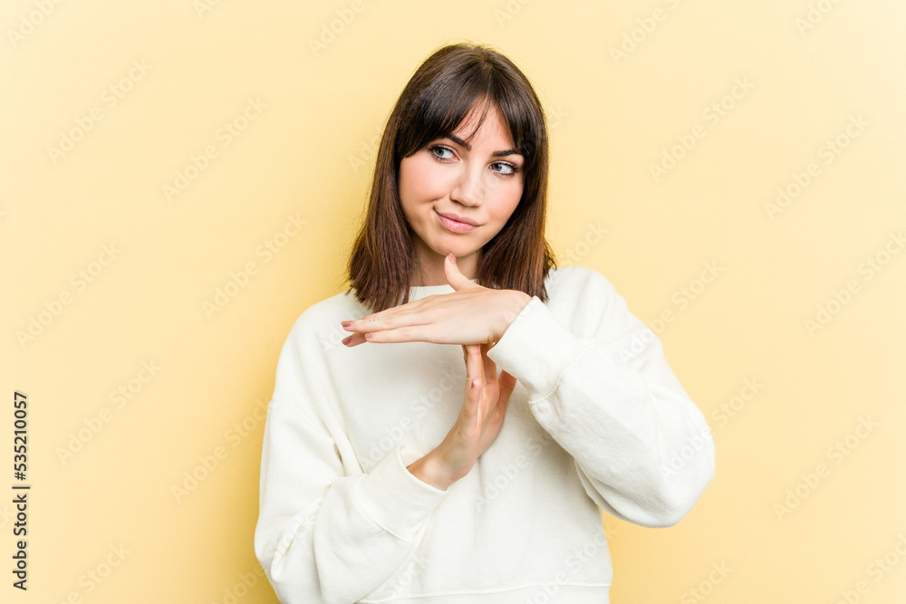 Young caucasian woman isolated on yellow background showing a timeout gesture. Young caucasian woman isolated on yellow background showing a timeout gesture.