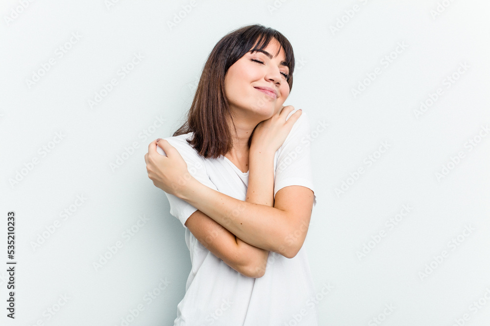 Young caucasian woman isolated on white background hugs, smiling carefree and happy. Young caucasian woman isolated on white background hugs, smiling carefree and happy.
