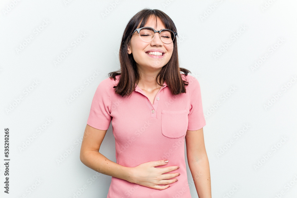 Young caucasian woman isolated on white background touches tummy, smiles gently, eating and satisfaction concept. Young caucasian woman isolated on white background touches tummy, smiles gently, eating and satisfaction concept.