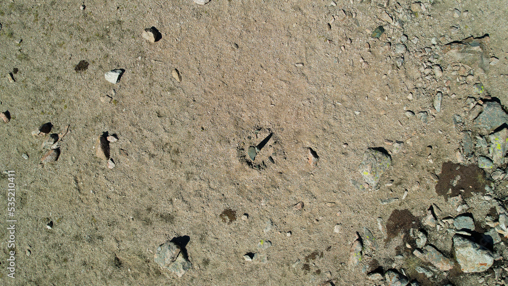 Drone view of a sundial made of stones. The shadow from the sun shows what time it is now. There are large stones lying around, moss grows in places. Sandy pass in the mountains. Kazakhstan Drone view of a sundial made of stones. The shadow from the sun shows what time it is now. There are large stones lying around, moss grows in places. Sandy pass in the mountains. Kazakhstan