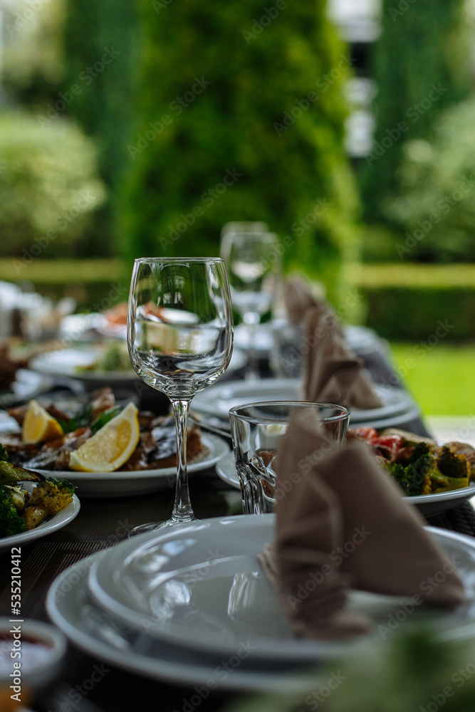 A table with beautiful dishes and prepared dishes on the summer terrace