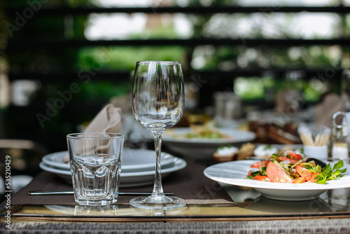 A table with beautiful dishes and prepared dishes on the summer terrace