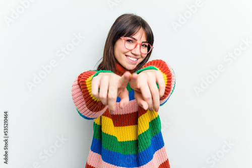 Young caucasian woman isolated on white background pointing to front with fingers.