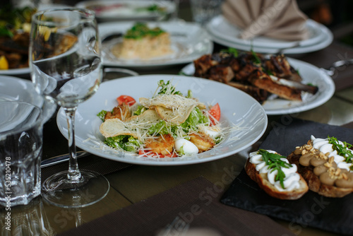 A table with beautiful dishes and prepared dishes on the summer terrace