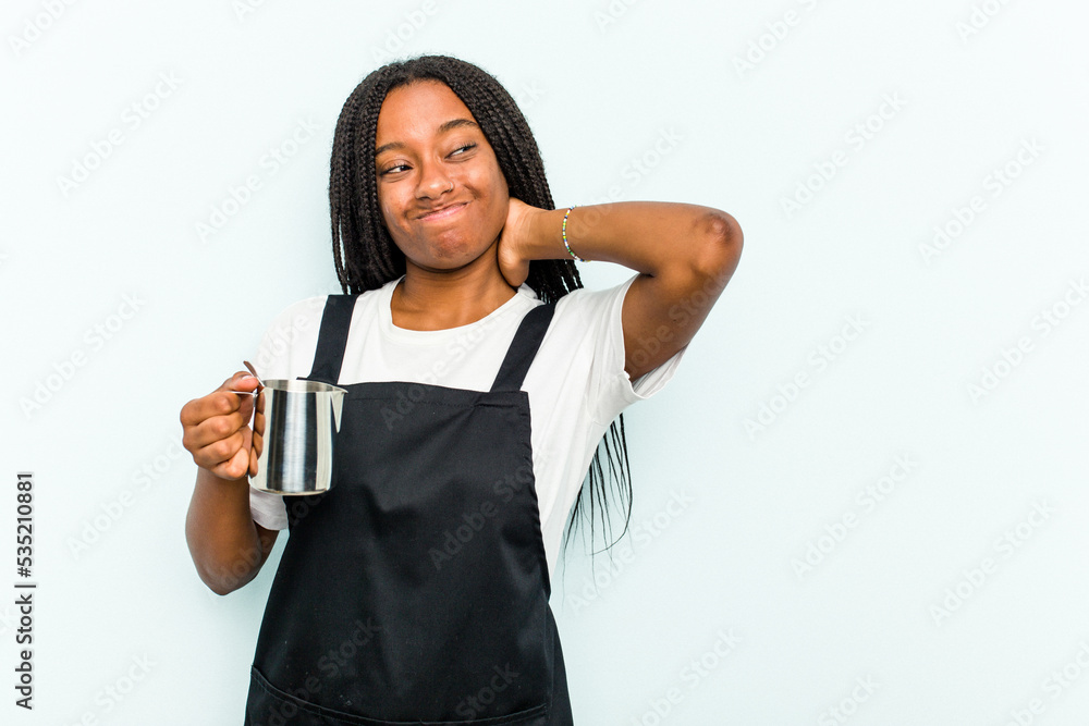 Young African American barista woman isolated on blue background touching back of head, thinking and making a choice. Young African American barista woman isolated on blue background touching back of head, thinking and making a choice.