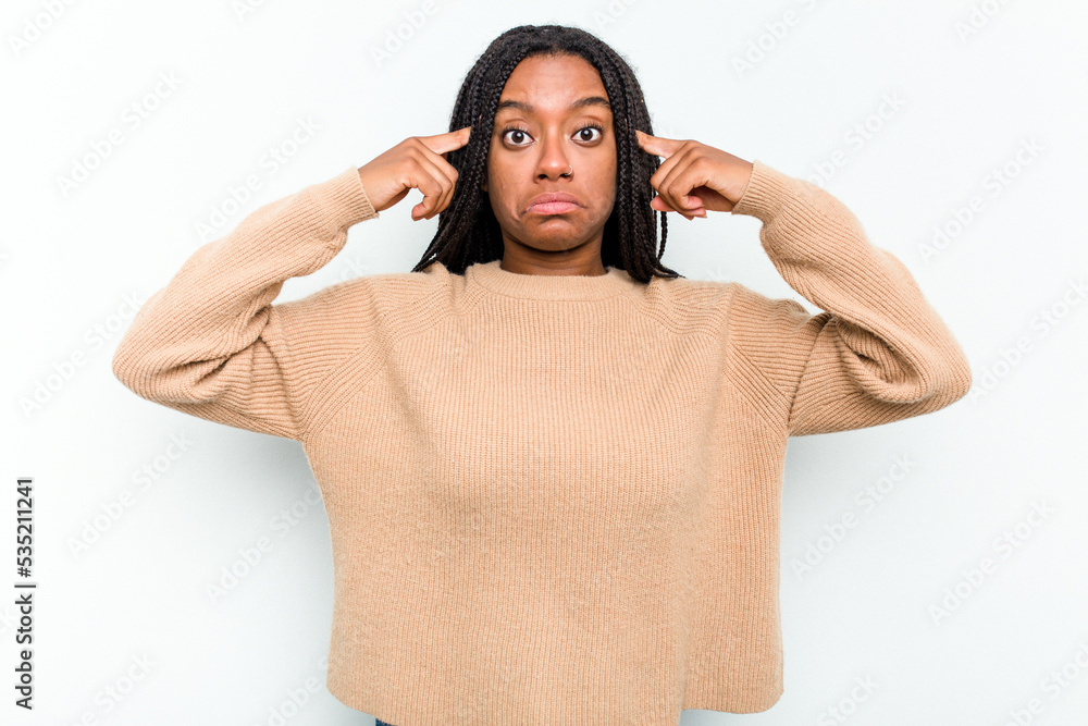 Young African American woman isolated on white background focused on a task, keeping forefingers pointing head. Young African American woman isolated on white background focused on a task, keeping forefingers pointing head.