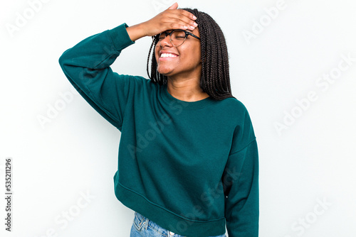 Young African American woman isolated on white background laughs joyfully keeping hands on head. Happiness concept. © Asier
