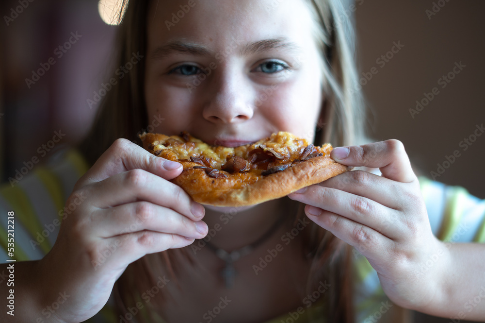 Cute teenage girl eating pizza, close-up of face with blue eyes Cute teenage girl eating pizza, close-up of face with blue eyes