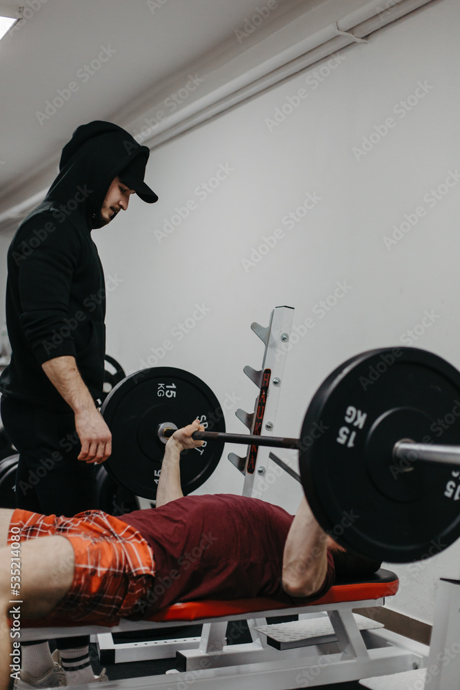 Fototapeta premium Young man trains his body to stay fit and have defined muscles.