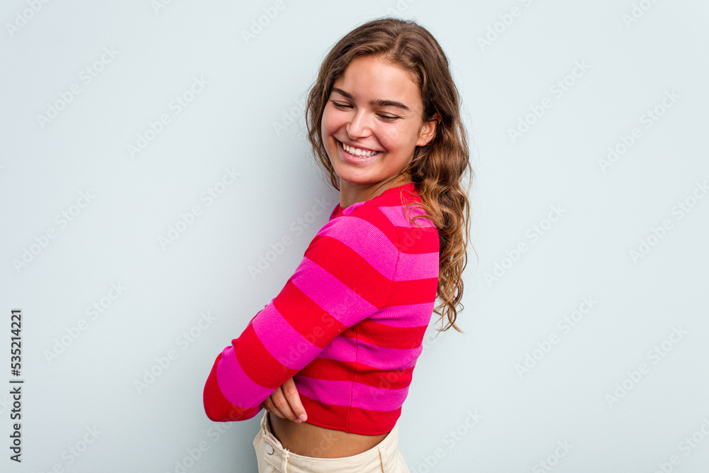 Young caucasian woman isolated on blue background laughing and having fun. Young caucasian woman isolated on blue background laughing and having fun.