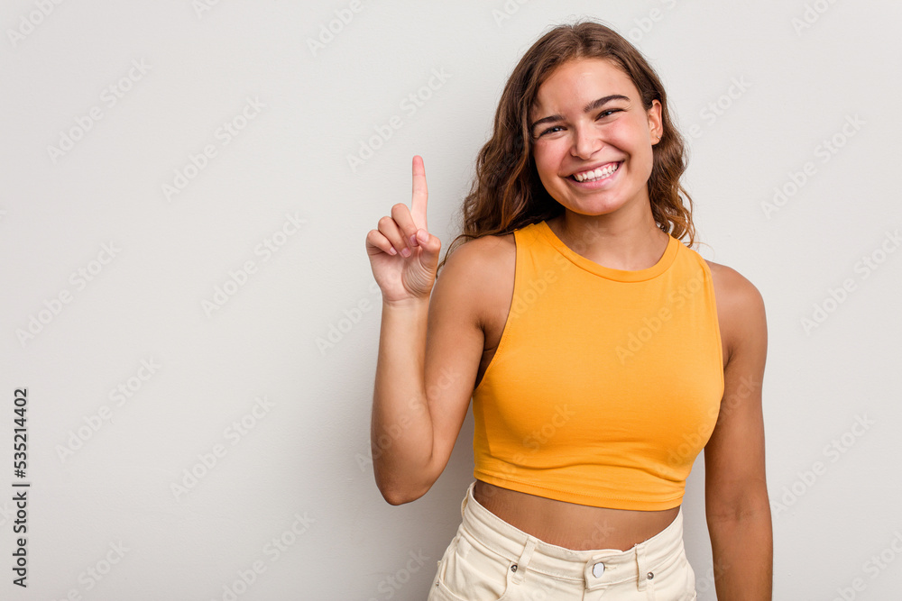Young caucasian woman isolated on blue background showing number one with finger. Young caucasian woman isolated on blue background showing number one with finger.