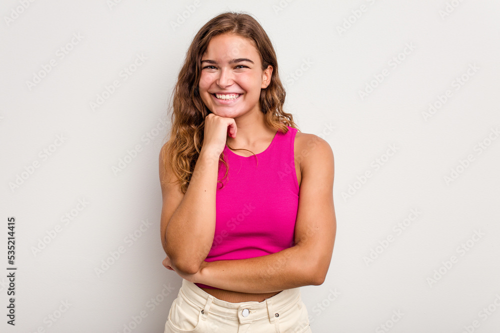 Young caucasian woman isolated on blue background smiling happy and confident, touching chin with hand. Young caucasian woman isolated on blue background smiling happy and confident, touching chin with hand.