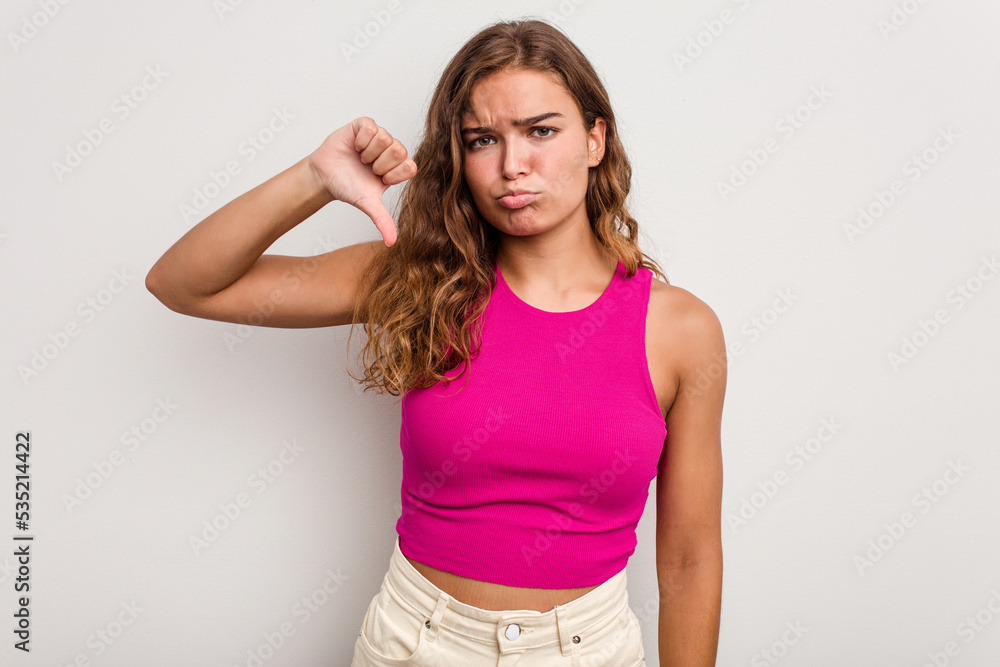 Young caucasian woman isolated on blue background showing thumb down, disappointment concept. Young caucasian woman isolated on blue background showing thumb down, disappointment concept.