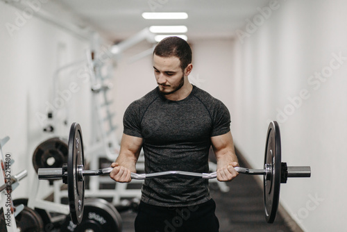 Young man trains his body to stay fit and have defined muscles.