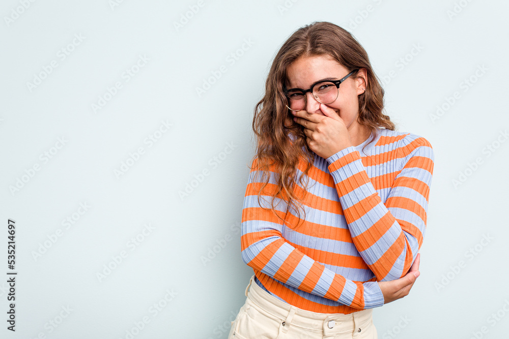 Young caucasian woman isolated on blue background laughing happy, carefree, natural emotion. Young caucasian woman isolated on blue background laughing happy, carefree, natural emotion.