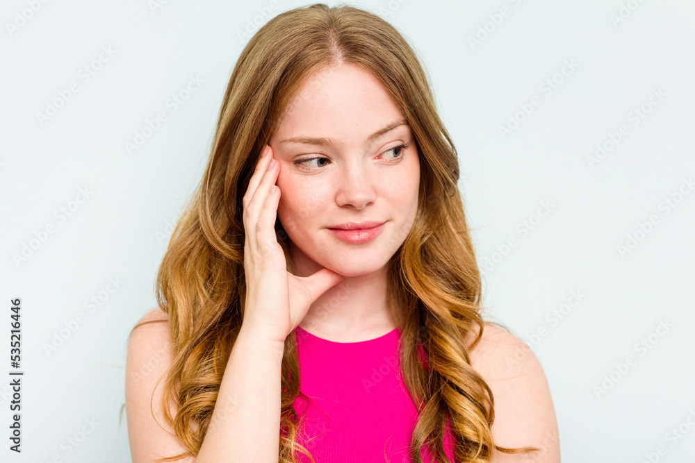 Portrait of pretty young caucasian woman isolated on blue background Portrait of pretty young caucasian woman isolated on blue background