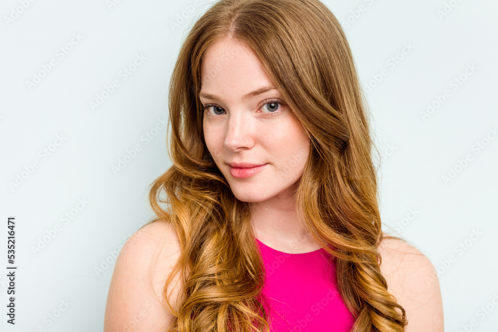Portrait of pretty young caucasian woman isolated on blue background Portrait of pretty young caucasian woman isolated on blue background