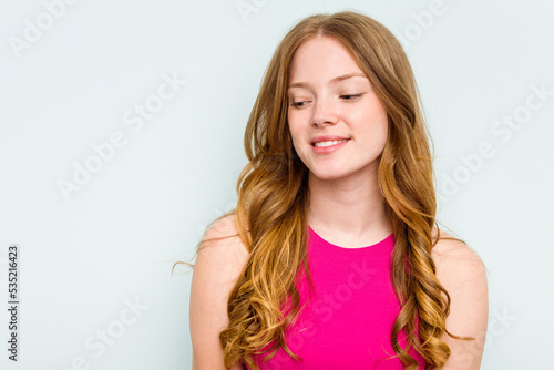 Portrait of pretty young caucasian woman isolated on blue background