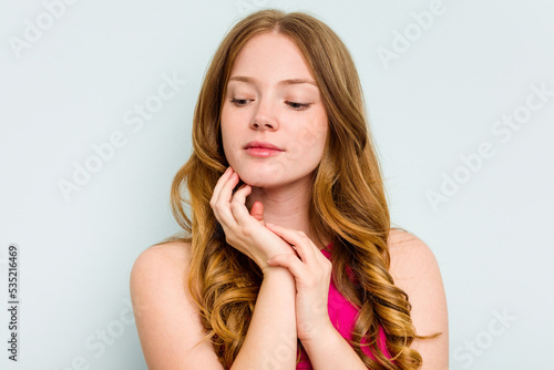 Portrait of pretty young caucasian woman isolated on blue background