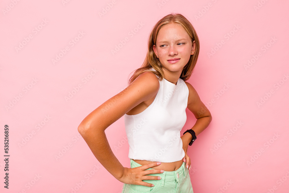 Caucasian teen girl isolated on pink background suffering a back pain. Caucasian teen girl isolated on pink background suffering a back pain.