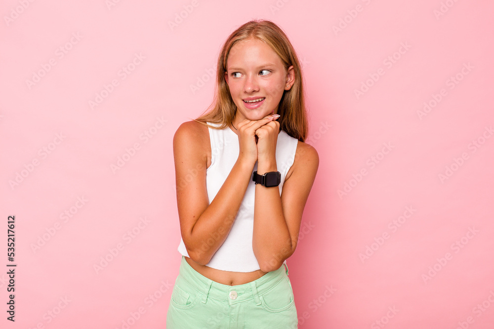 Caucasian teen girl isolated on pink background praying for luck, amazed and opening mouth looking to front. Caucasian teen girl isolated on pink background praying for luck, amazed and opening mouth looking to front.