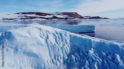Huge high ice glacier at polar nature environment. Arctic winter landscape at global warming problem. Desert white land of snow and ice drone shot. 