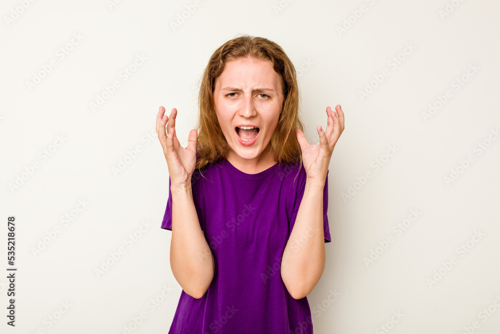 Young caucasian woman isolated on white background screaming with rage. Young caucasian woman isolated on white background screaming with rage.
