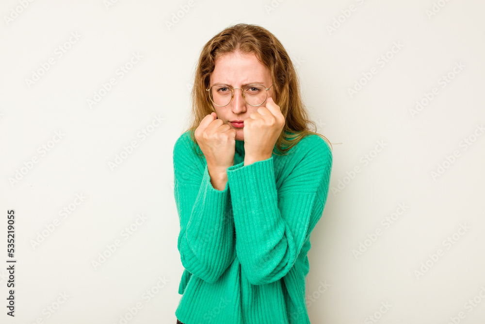 Young caucasian woman isolated on white background throwing a punch, anger, fighting due to an argument, boxing. Young caucasian woman isolated on white background throwing a punch, anger, fighting due to an argument, boxing.