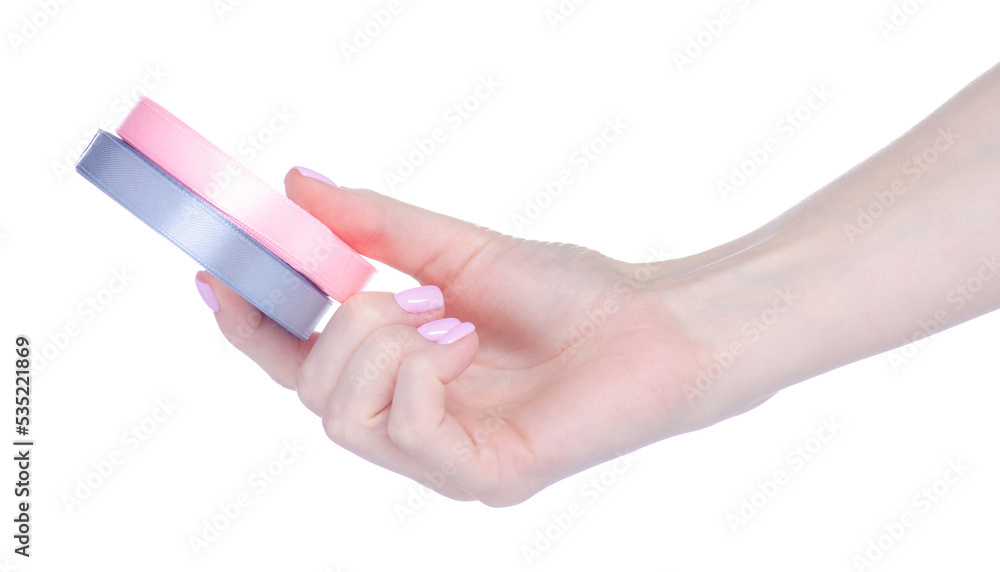 Roll pink and gray ribbon in hand on white background isolation Roll pink and gray ribbon in hand on white background isolation