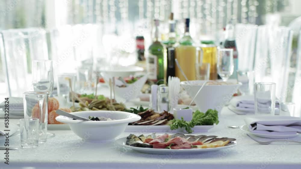 Beautiful table setting for a holiday. Lots of delicious food. Modern glasses and dishes Beautiful table setting for a holiday. Lots of delicious food. Modern glasses and dishes