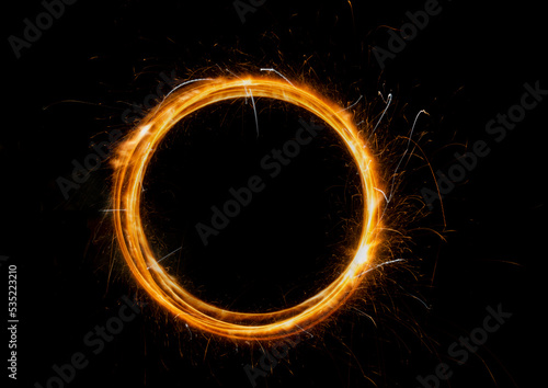 Circle of fire with copy space on black abstract banner. Burning sparklers