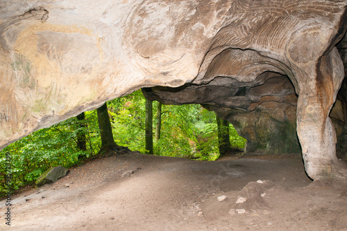 Huel Lee or Hohllay on the Mullerthal trail in Luxembourg, open cave with view to the forest, sandstone rock formation photo